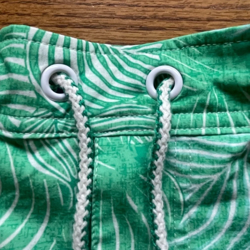 Johnnie-O swim shorts- green leaf design- size men’s large elastic in back.